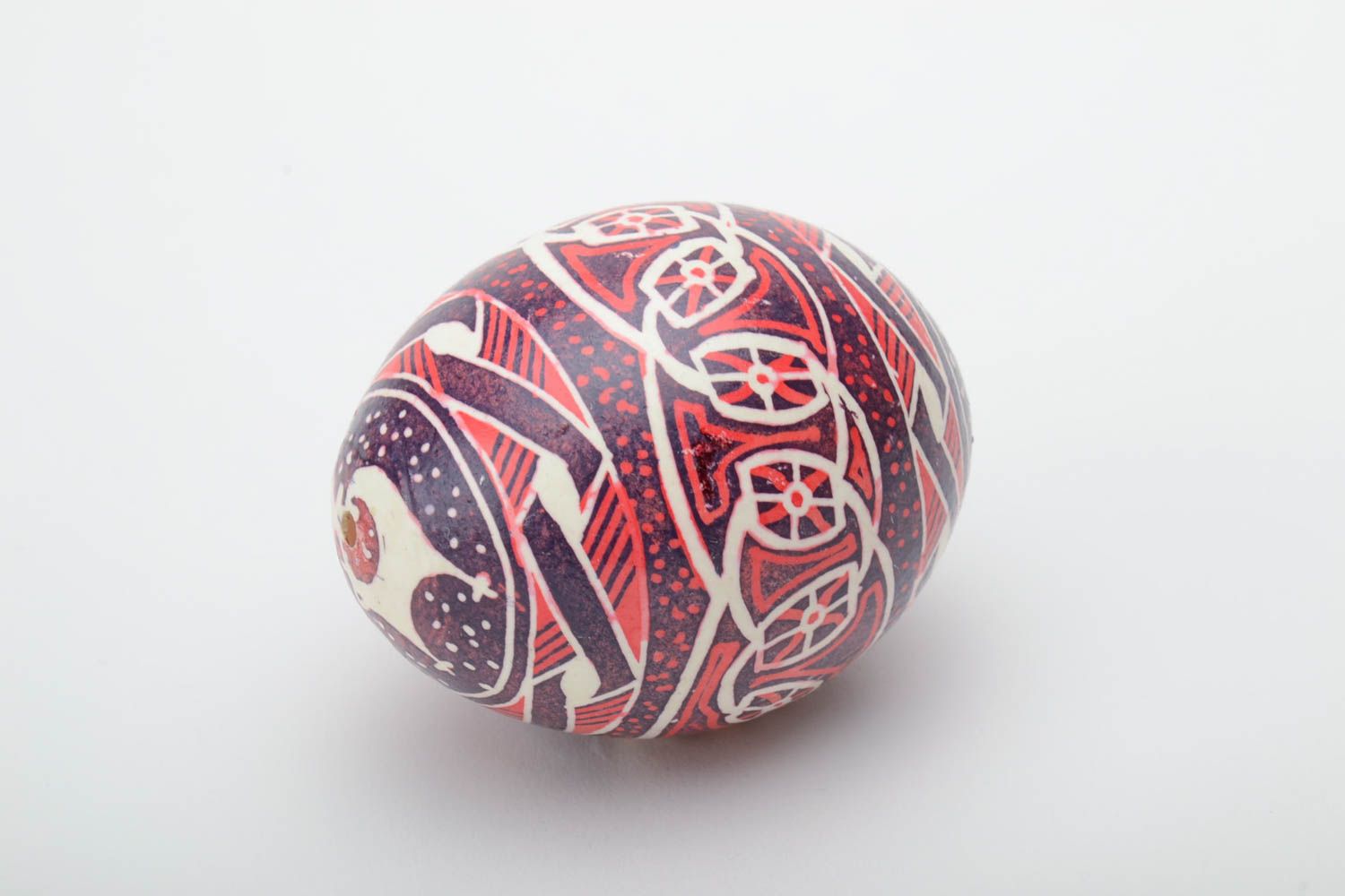 Homemade decorative ethnic painted Easter egg pysanka in red color palette photo 2