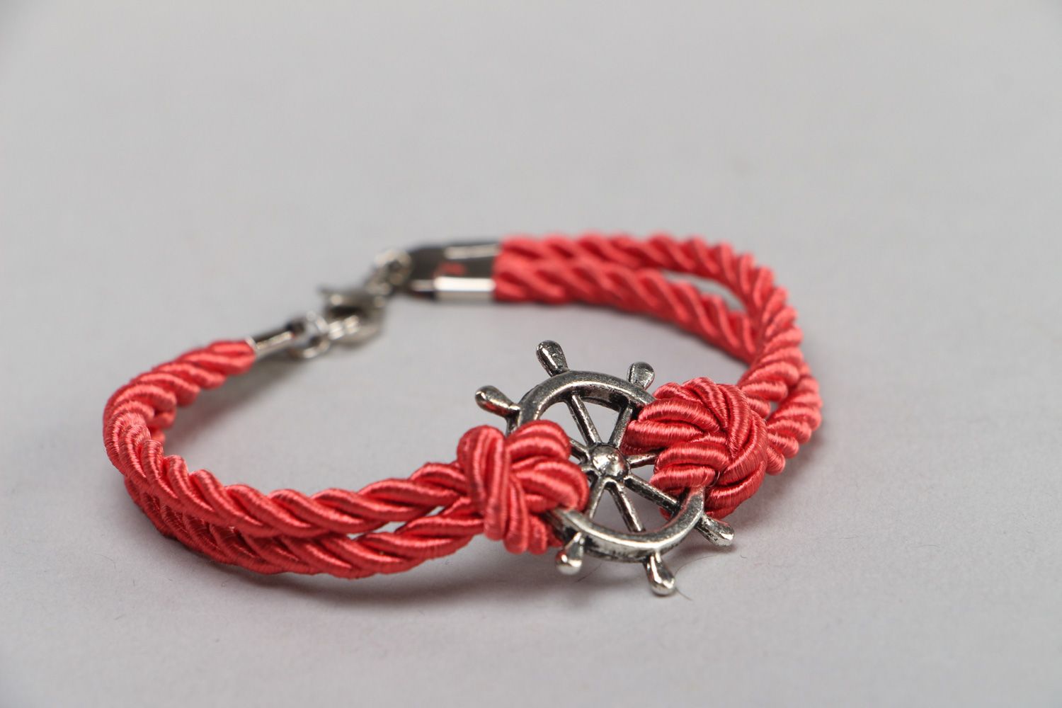 Handmade thin wrist bracelet with red cord and metal steering wheel unisex photo 1