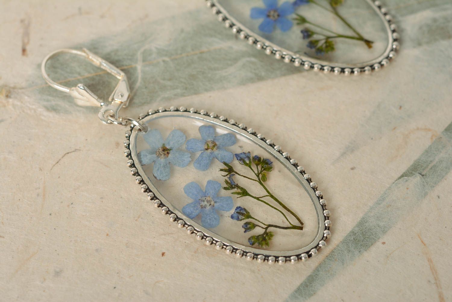 Handmade oval transparent dangle earrings with blue dried flowers in epoxy resin photo 4