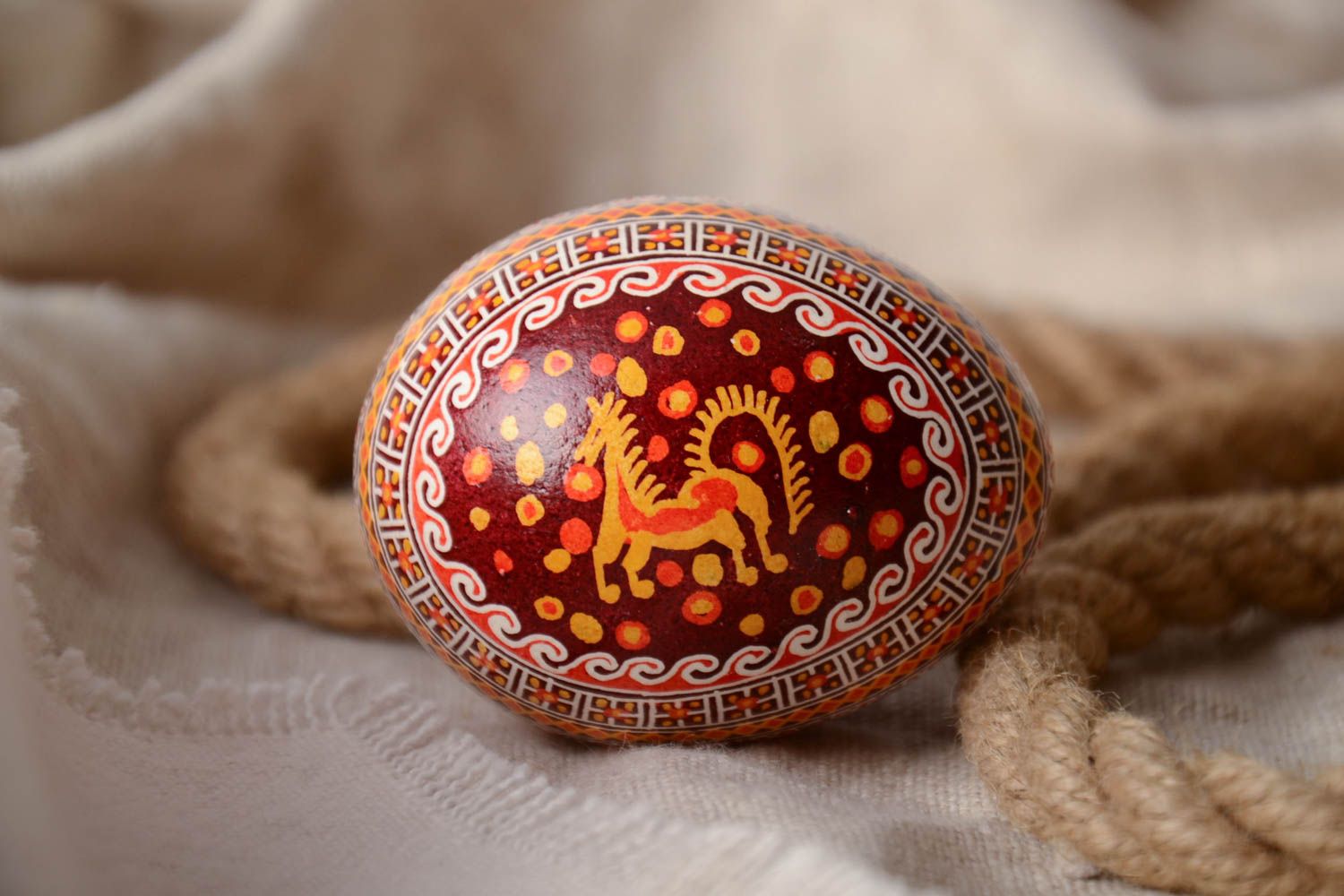 Homemade bright decorative painted Easter egg pysanka with image of horse photo 1