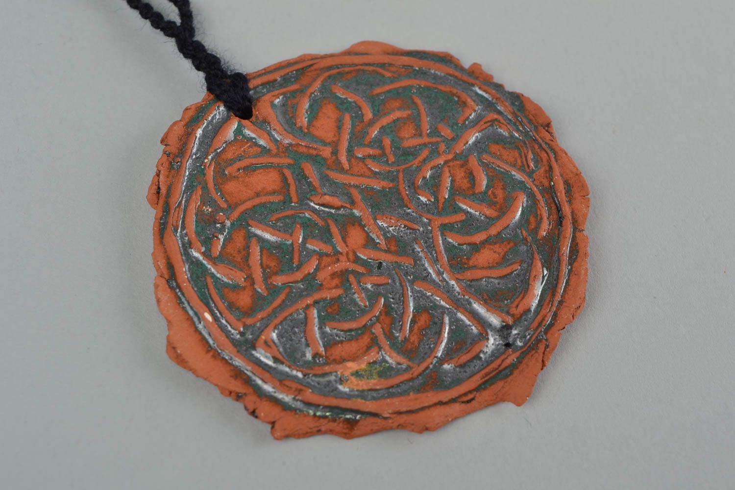 Handmade women's designer ceramic round pendant with relief ornament on cord photo 4