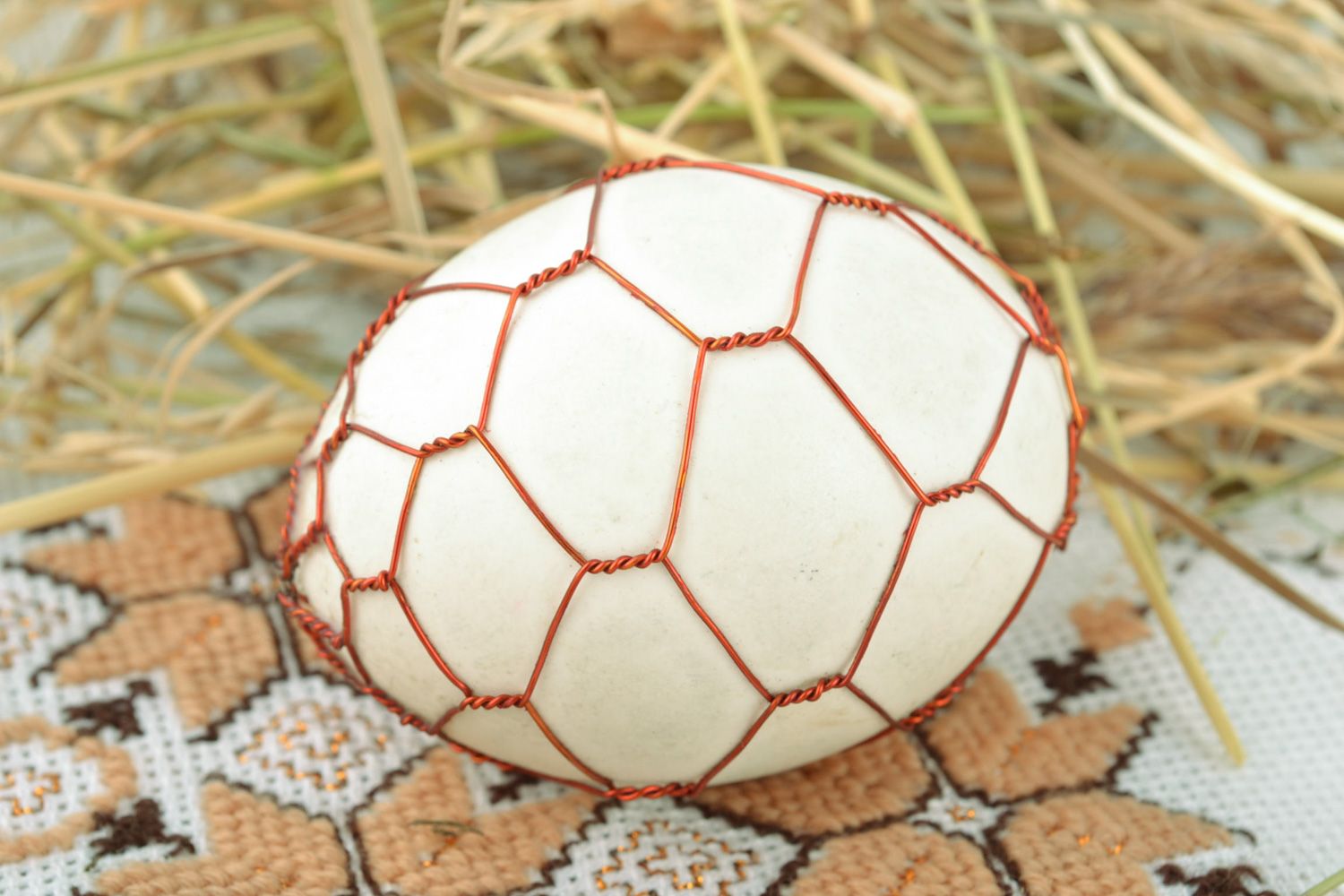 Handmade decorative Easter egg woven over with copper wire for interior decor photo 1