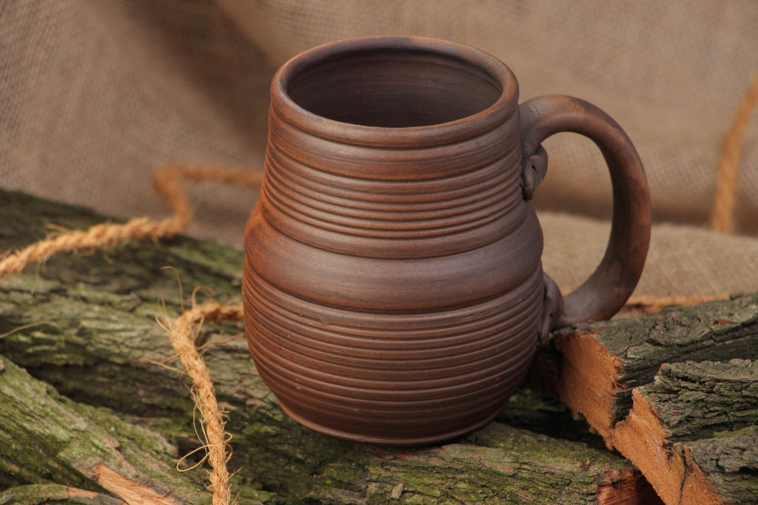 Homemade dark brown ceramic beer mug molded of red clay kilned with milk photo 1
