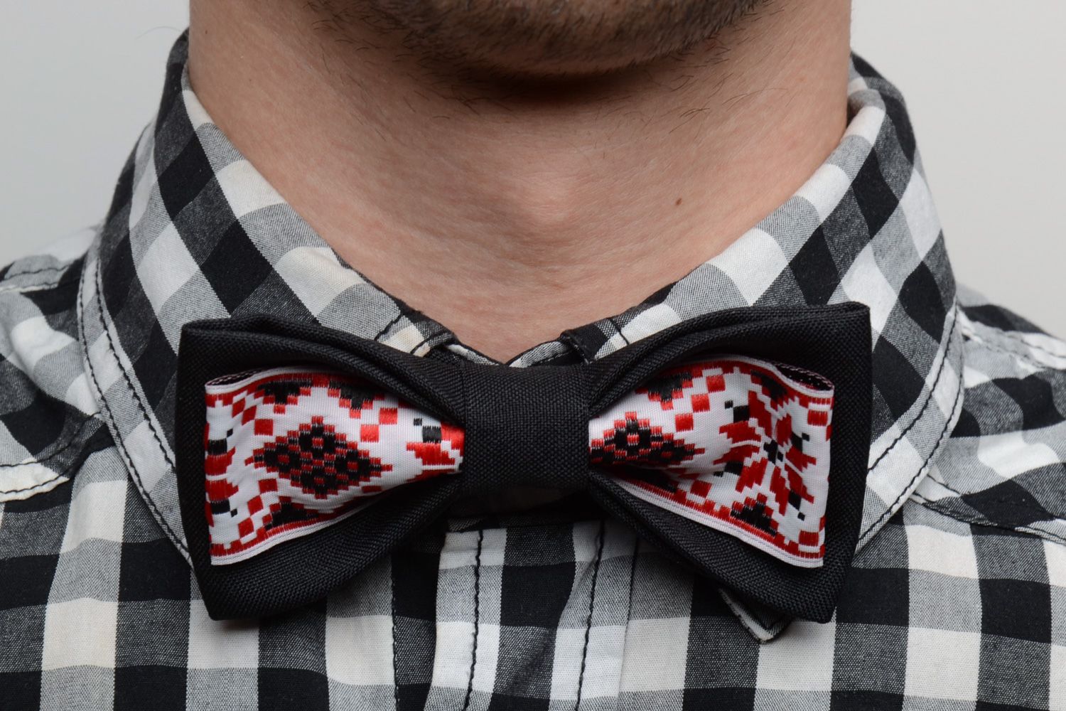 Handmade bow tie sewn of black and ornamented costume fabric in ethnic style photo 1