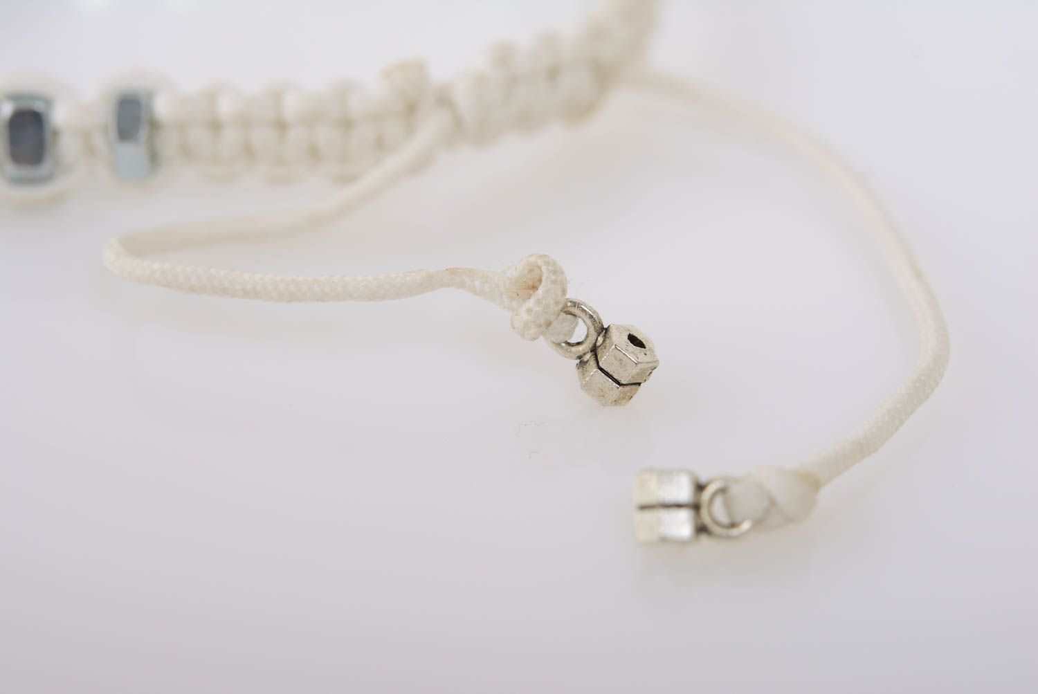 White handmade designer thin macrame woven cord bracelet with nuts photo 5