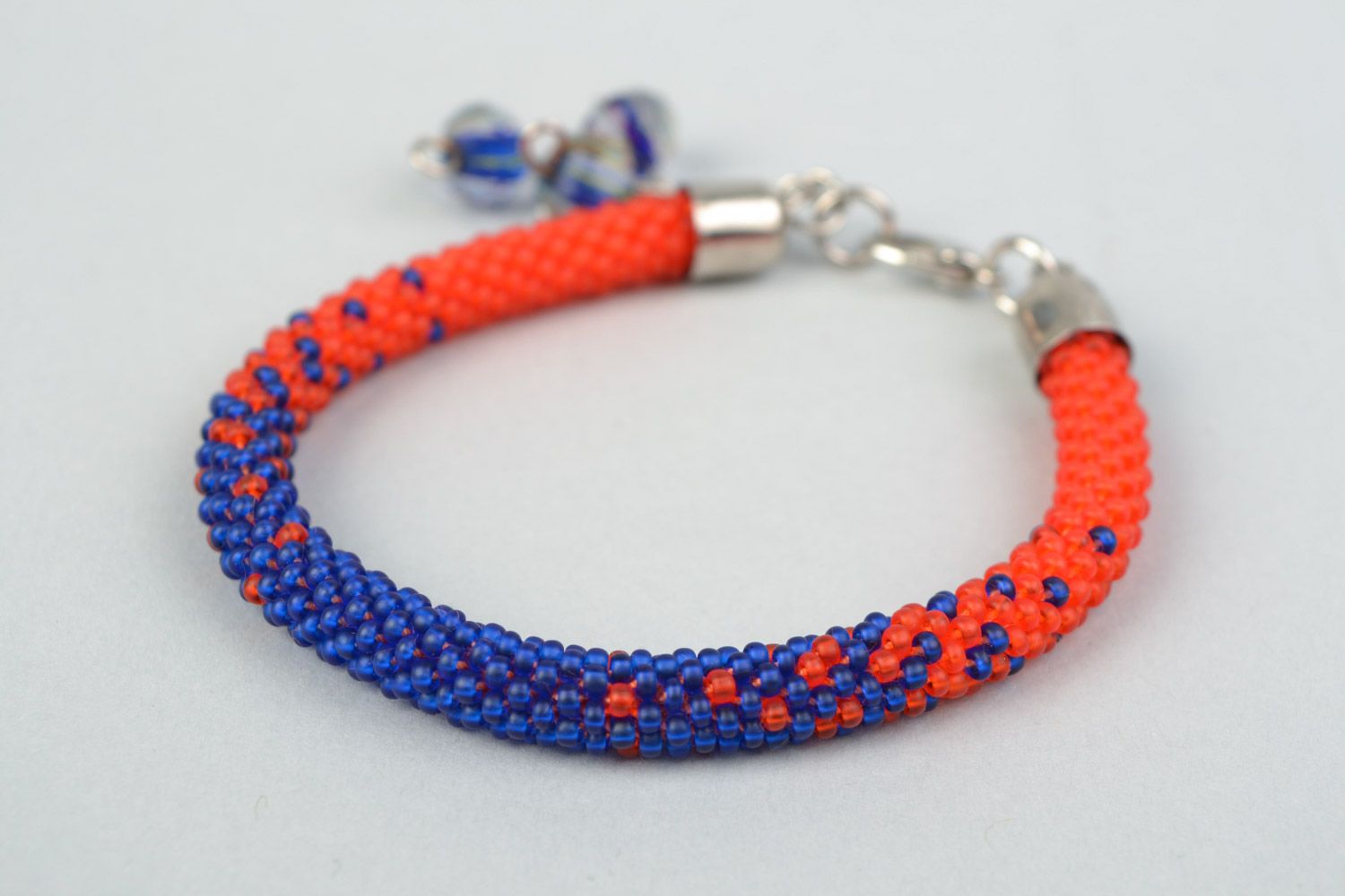 Handmade cord bracelet woven of bright red and blue Czech beads for women photo 3