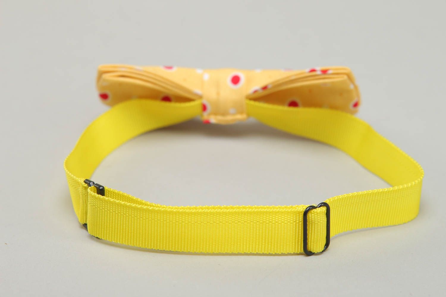 Bow tie made of yellow polka dot fabric photo 3