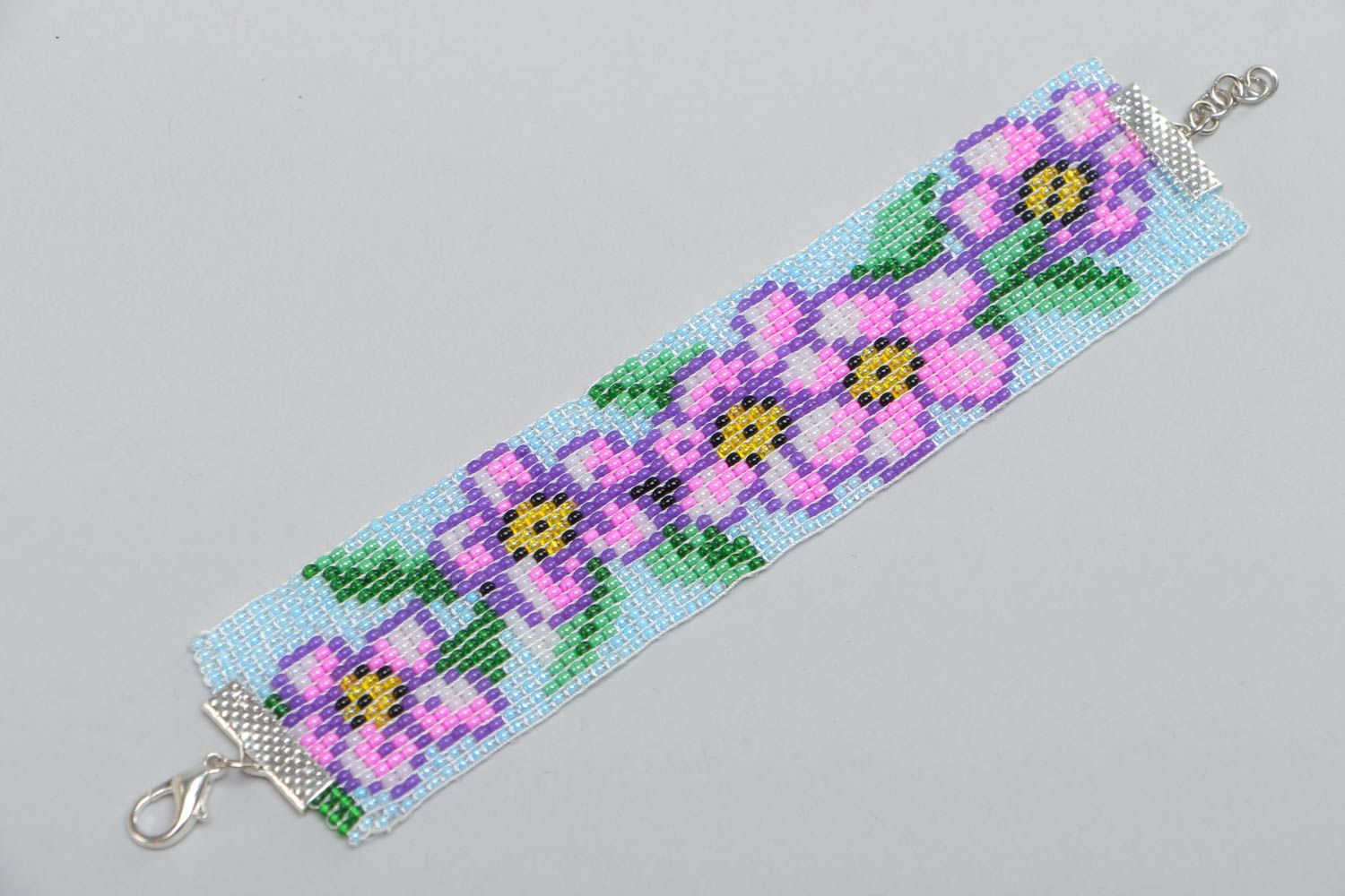 Handmade wide wrist bracelet woven of blue and violet beads with floral motives  photo 2