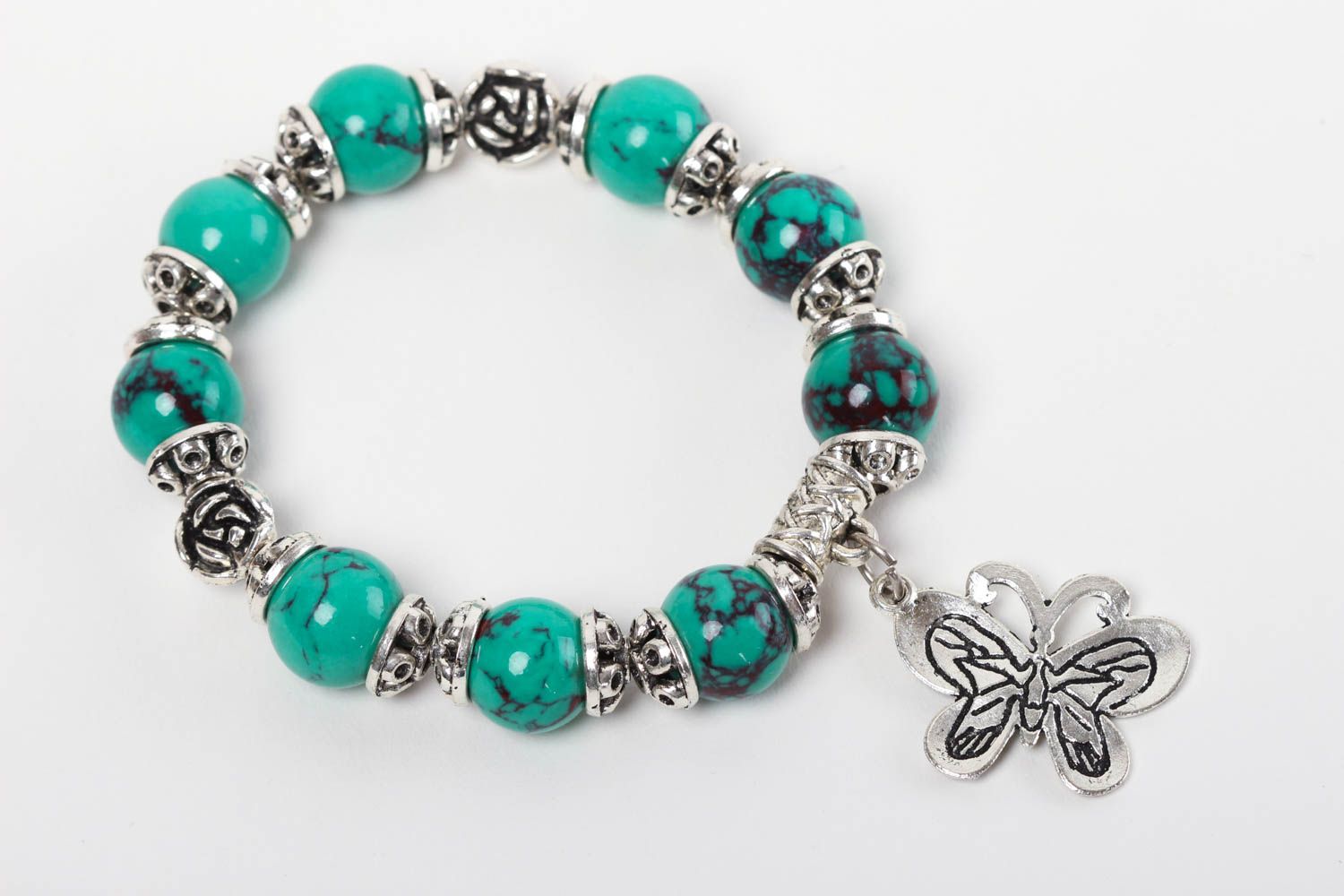 Natural turquoise stone beaded wrist bracelet with metal charms and central butterfly charm photo 2