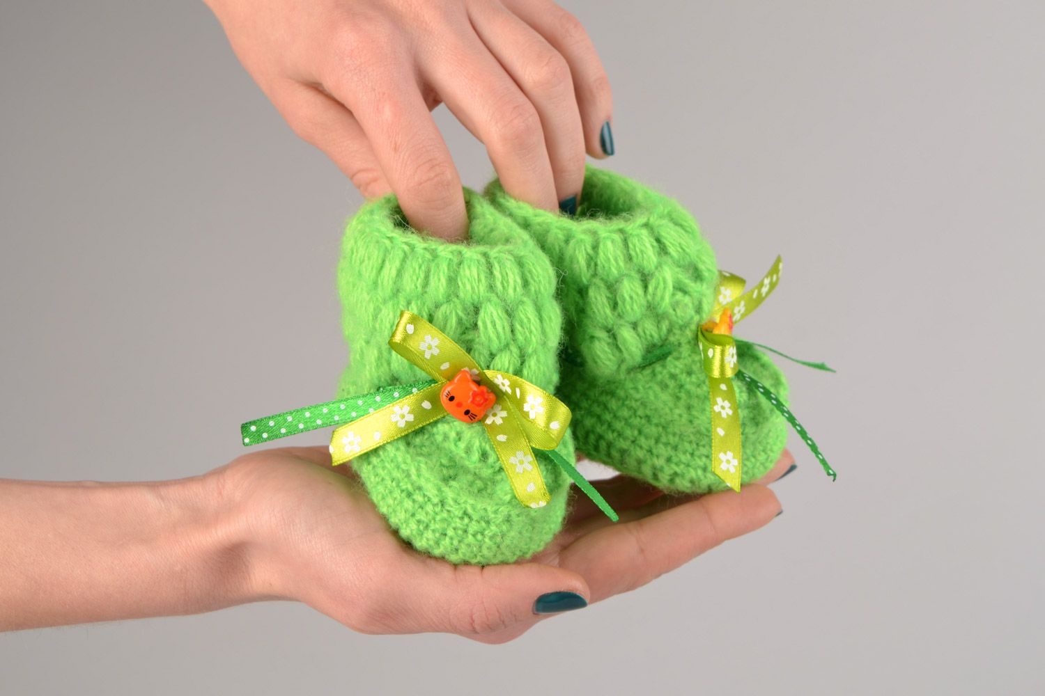 Handmade beautiful little crocheted booties for a baby girl with green bows  photo 2