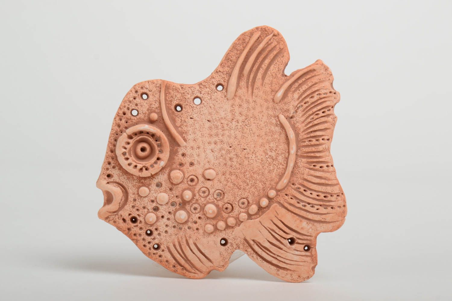 Homemade flat pendant molded of pottery clay in the shape of decorative fish photo 2