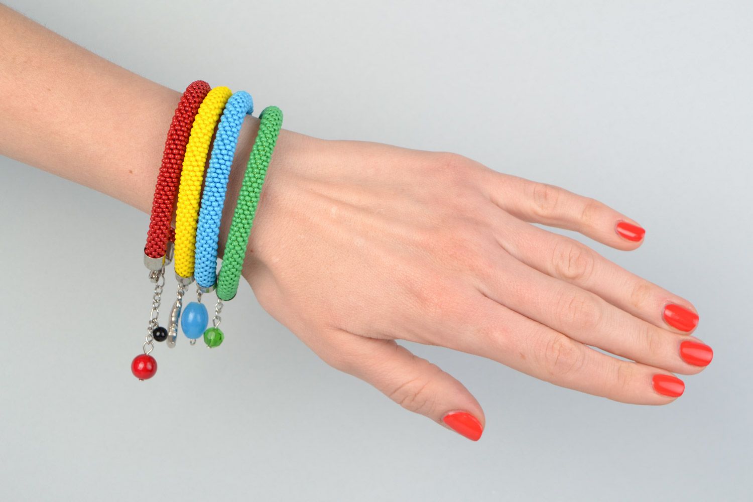 Set of bright beautiful braided handmade beaded bracelets 4 pieces photo 1
