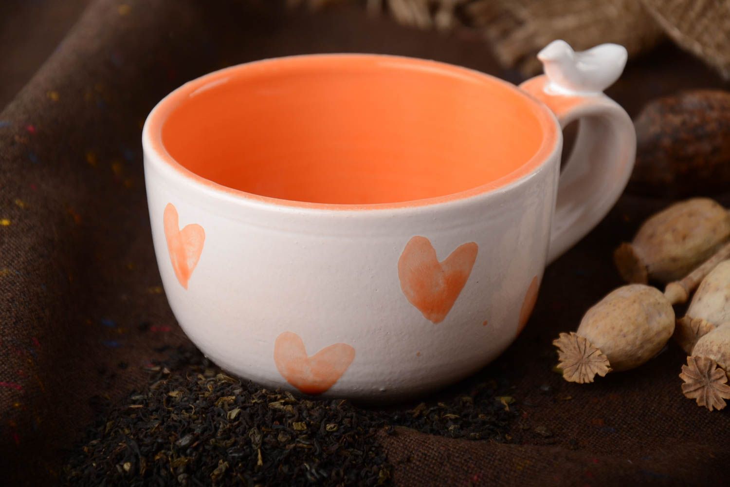8 oz orange and white glazed ceramic teacup with a bird on handle and heart pattern photo 1