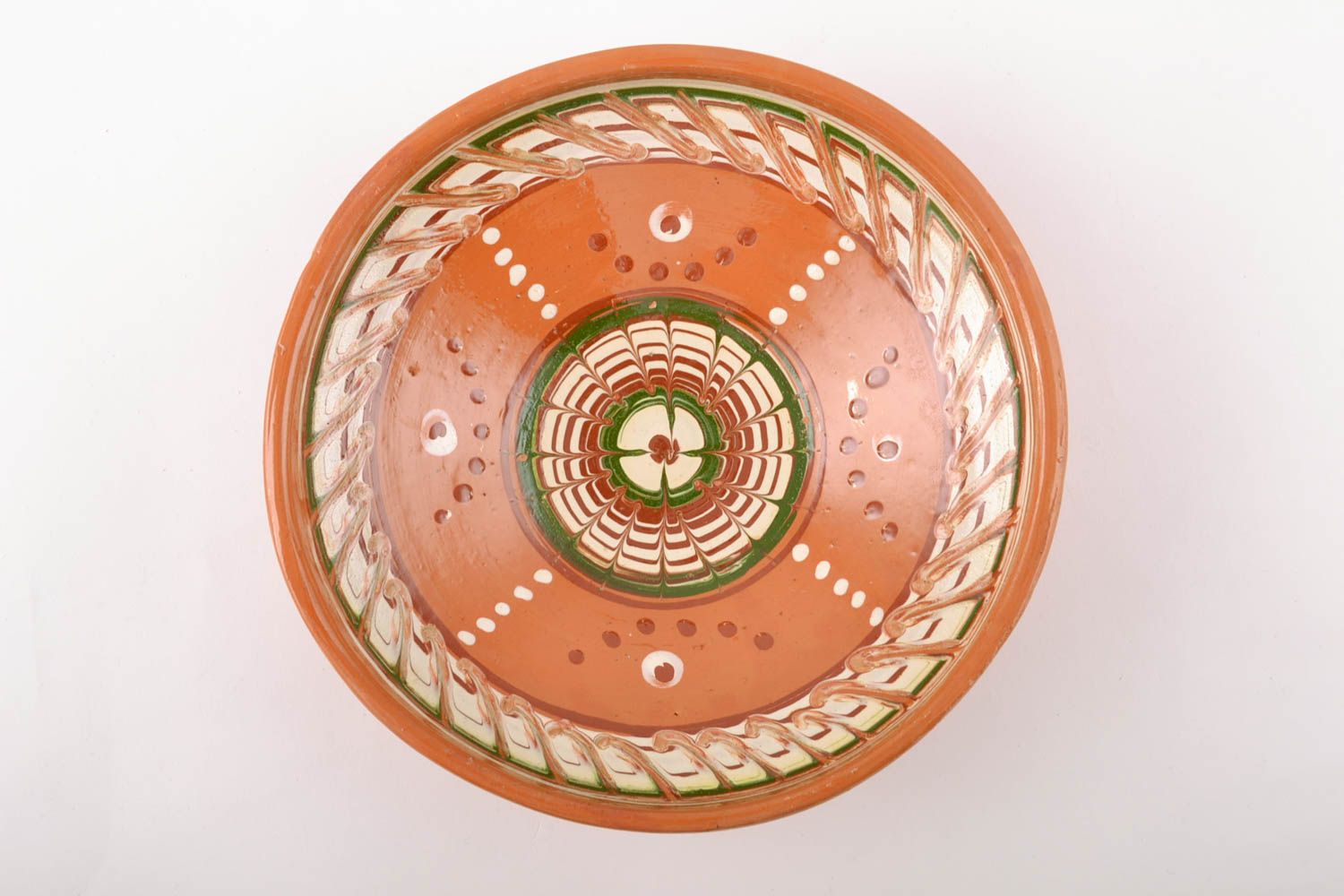 Glazed ceramic bowl made using engobes ornamenting technique photo 2