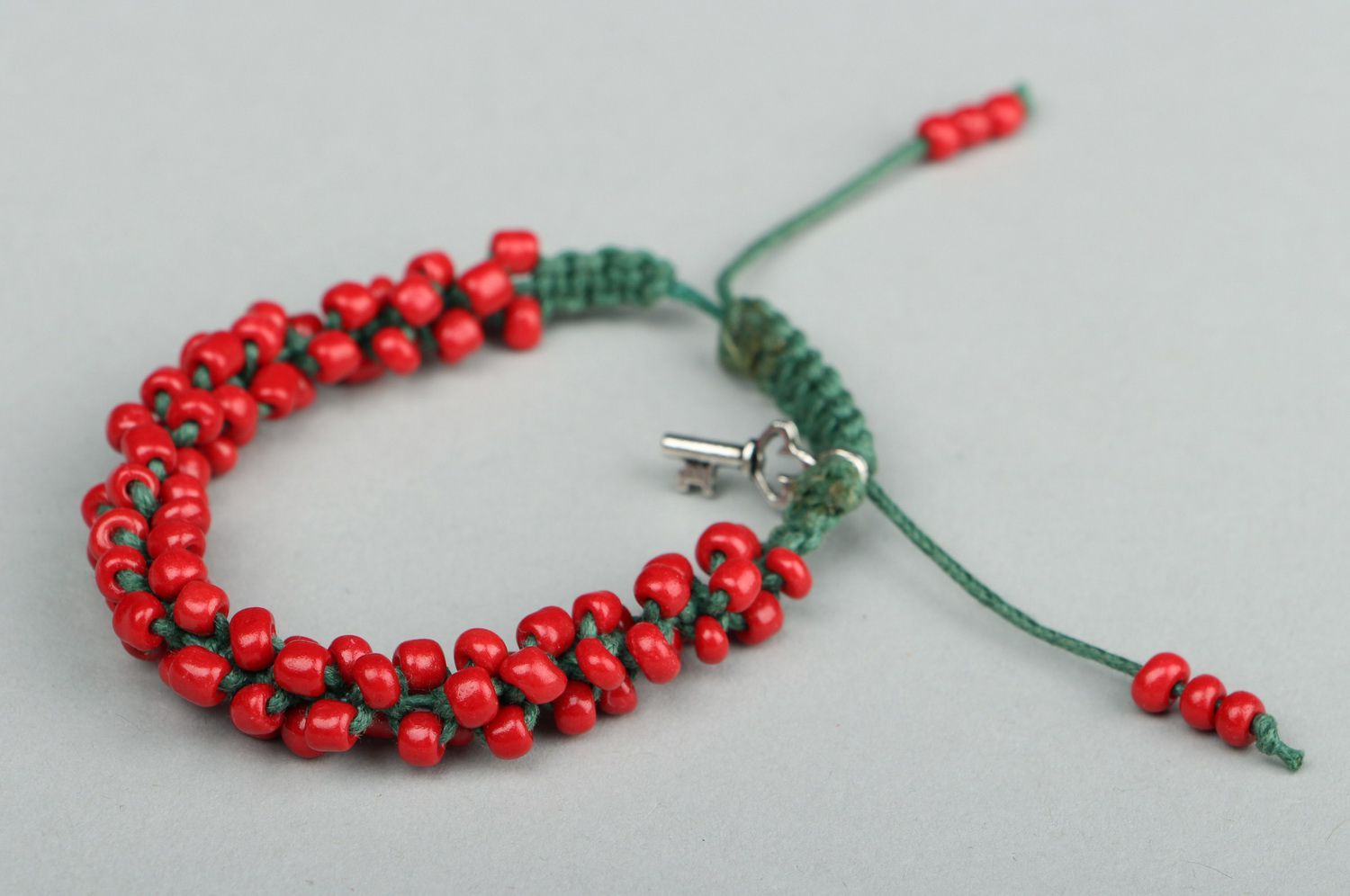 Red bracelet with beads photo 1