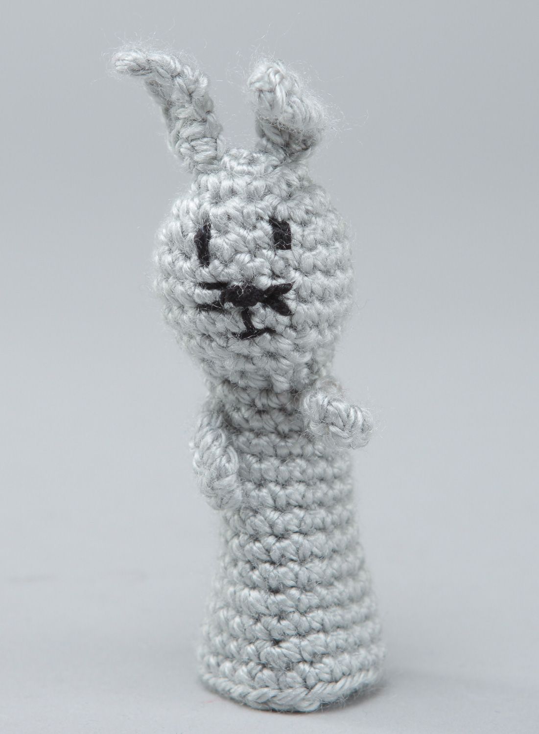 Handmade finger puppet in the shape of gray rabbit crocheted of acrylic threads photo 1