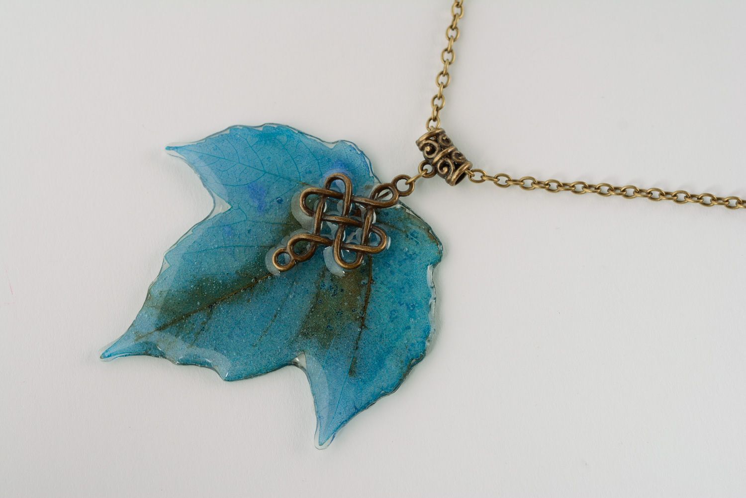 Handmade pendant with maple leave coated with epoxy and equipped with long chain photo 1