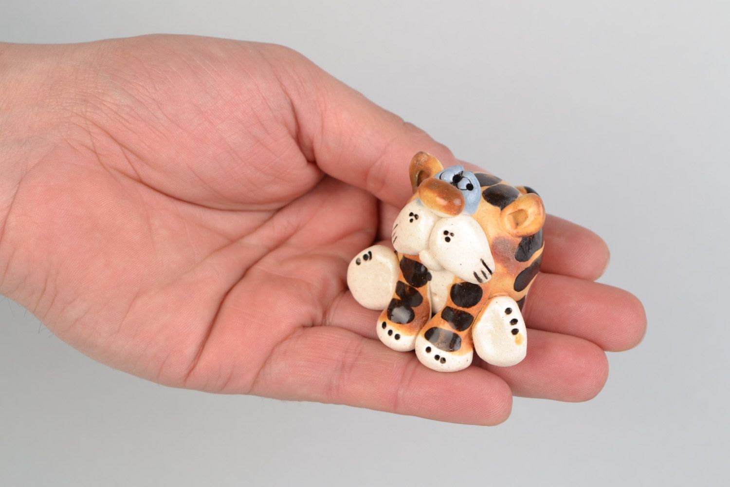 Handmade funny ceramic figurine of colorful sitting tiger painted with glazes photo 2