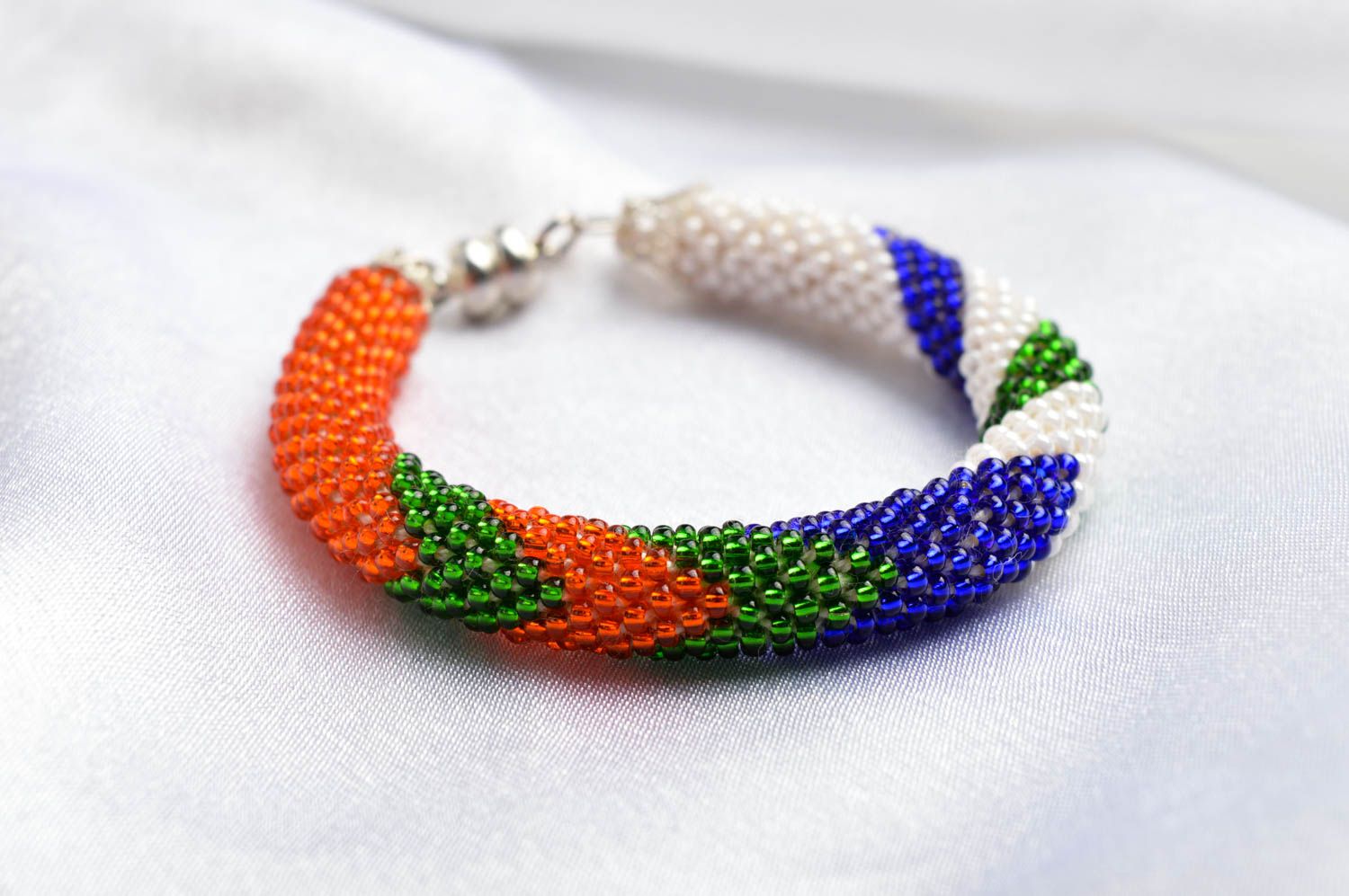 Bright handmade beaded bracelet in red, white, green, blue colors photo 1
