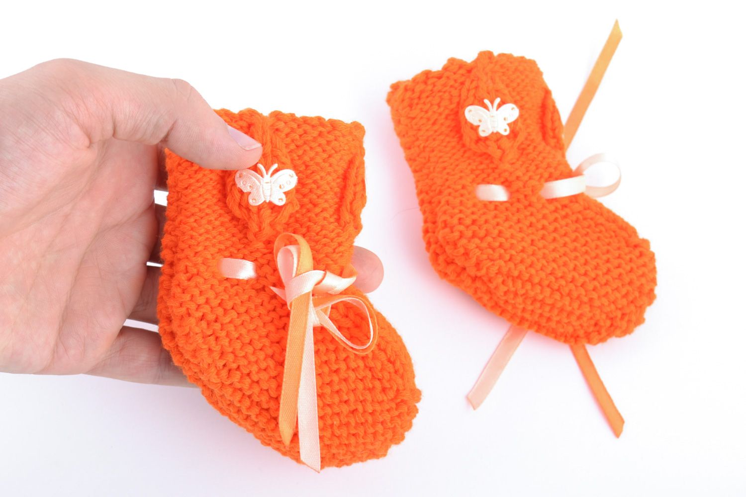 Handmade knitted wool baby bootees of orange color photo 3