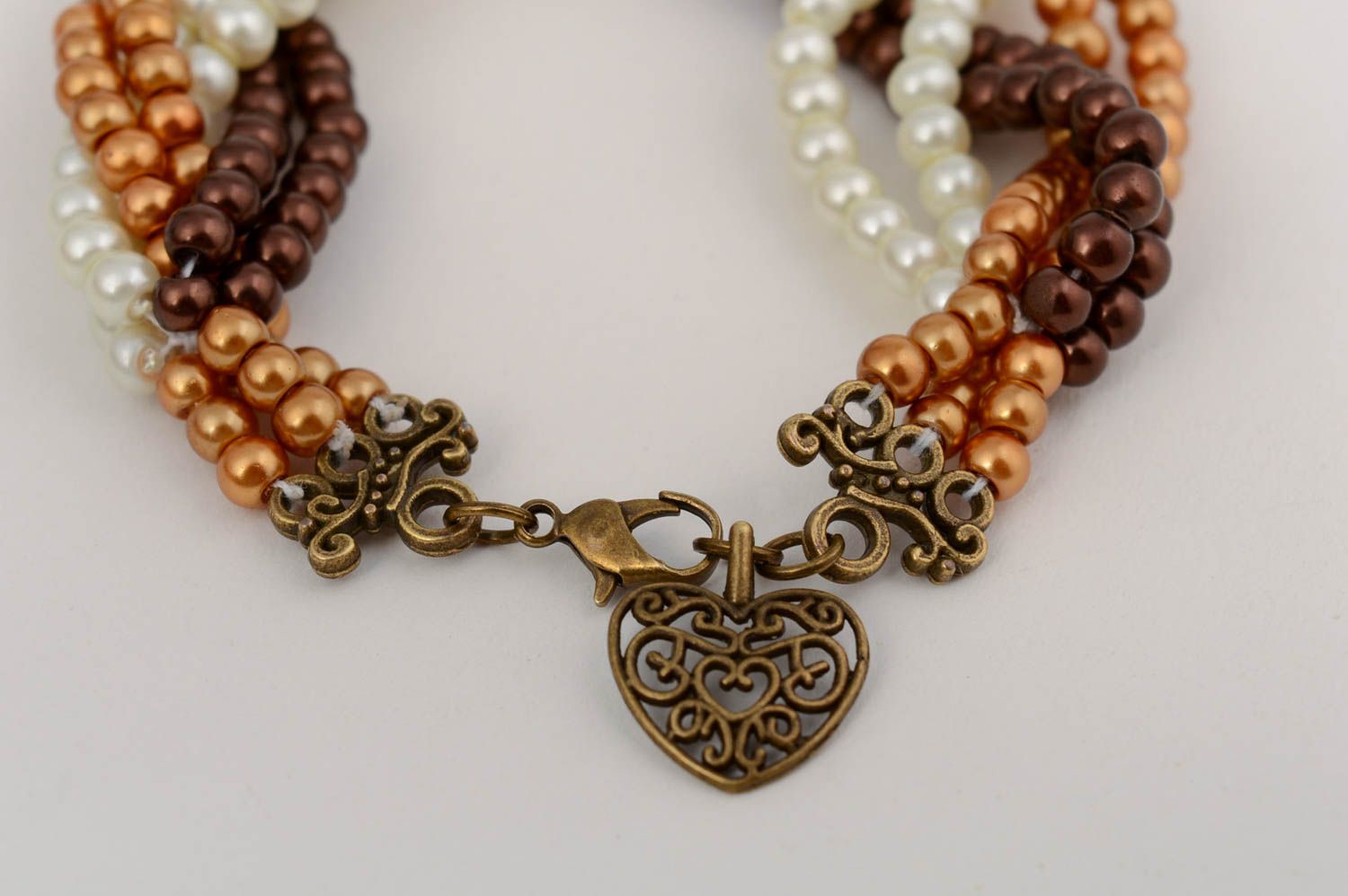 Handmade brown designer bracelet with ceramic pearls and metal heart charm photo 3