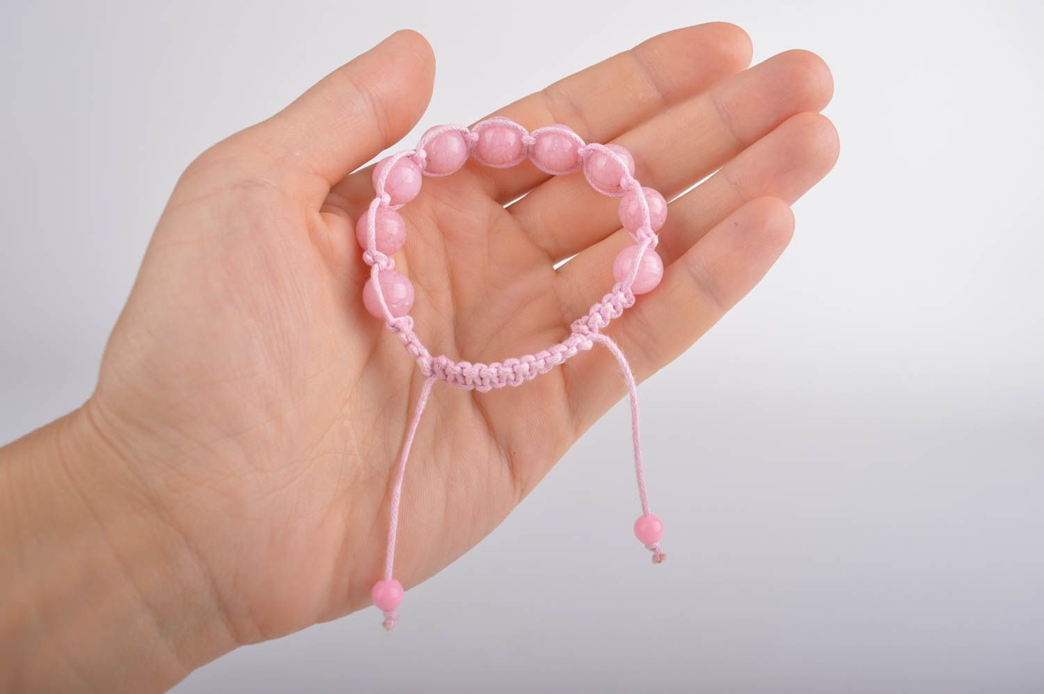 Light pink strand bracelet with pink cord and pink beads photo 5