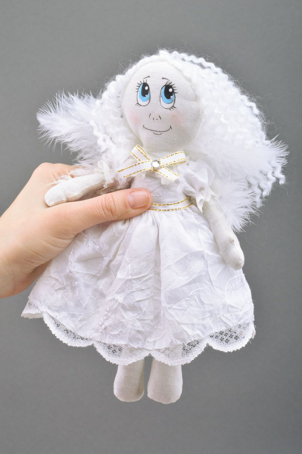 Handmade white fabric soft doll of average size with wings made of feathers photo 5