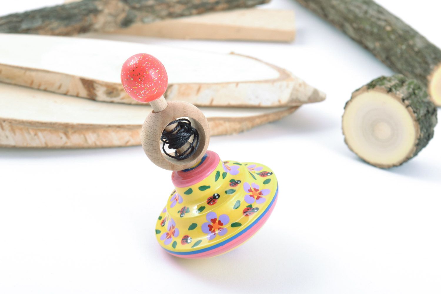Handmade educational wooden eco toy spinning top painted in yellow color palette photo 1