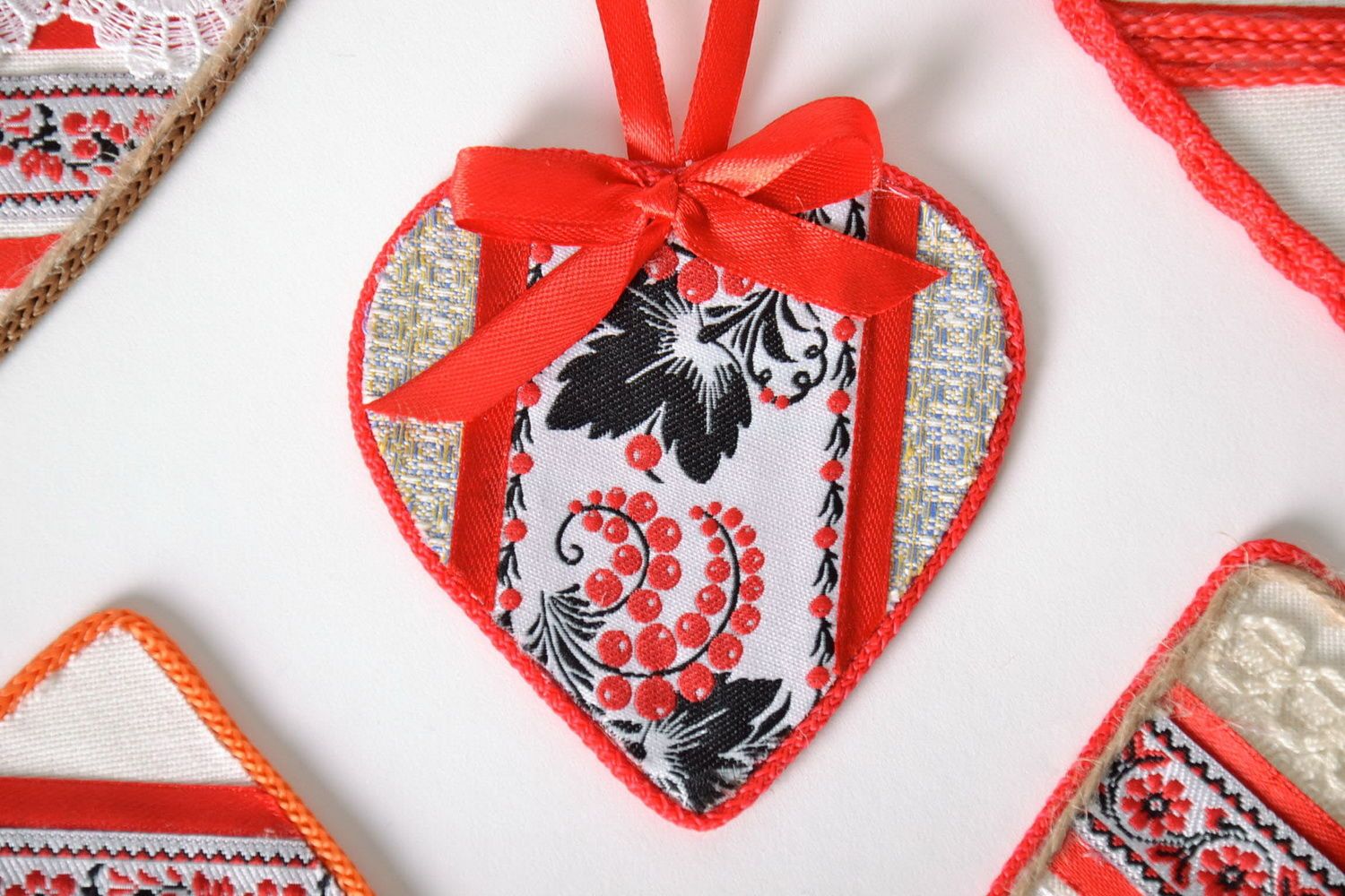 Heart-shaped amulet with ethnic embroidery photo 1