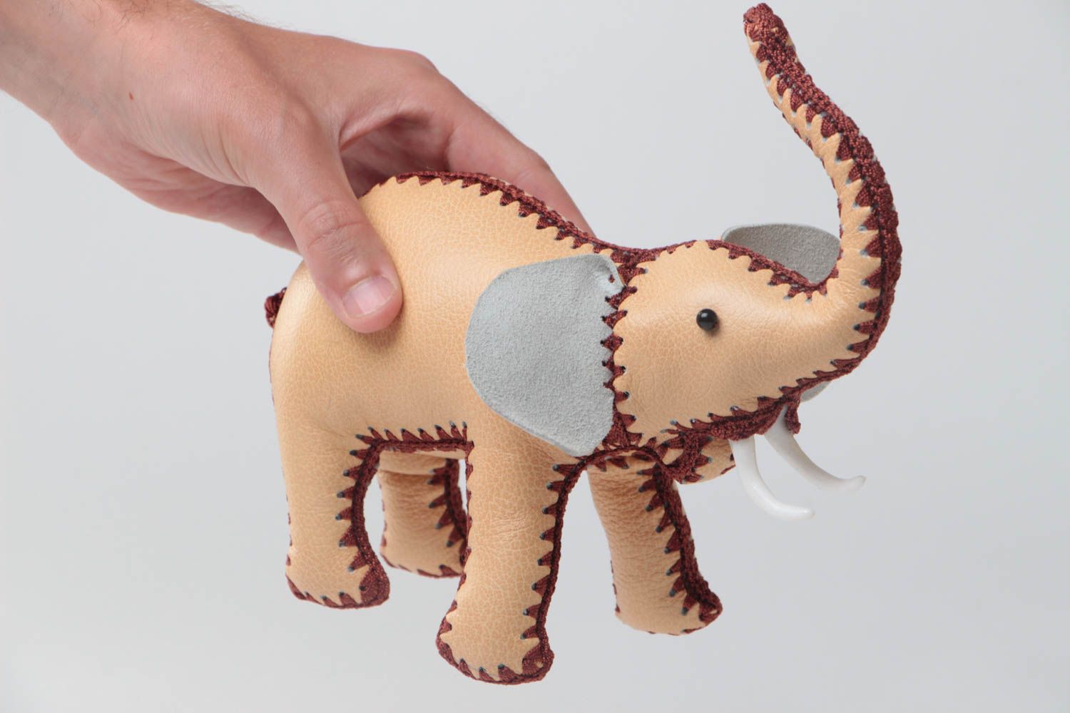 Handmade designer small soft toy elephant sewn of genuine leather of beige color photo 5