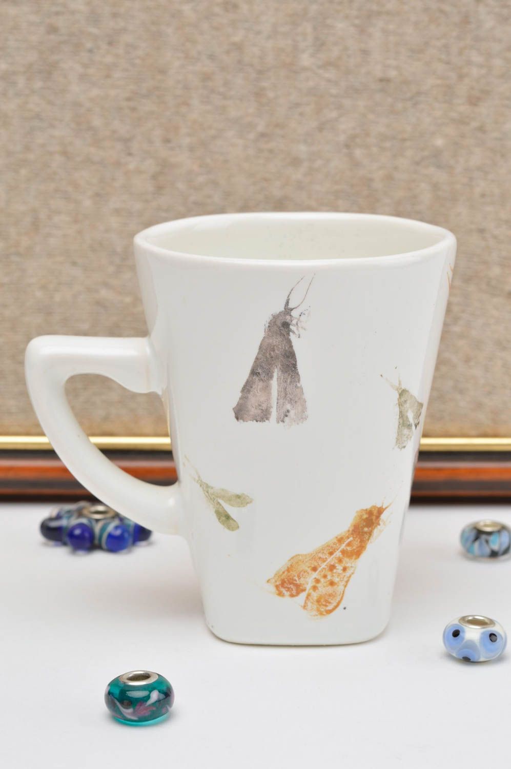 White porcelain drinking cup with handle and insects prints photo 1