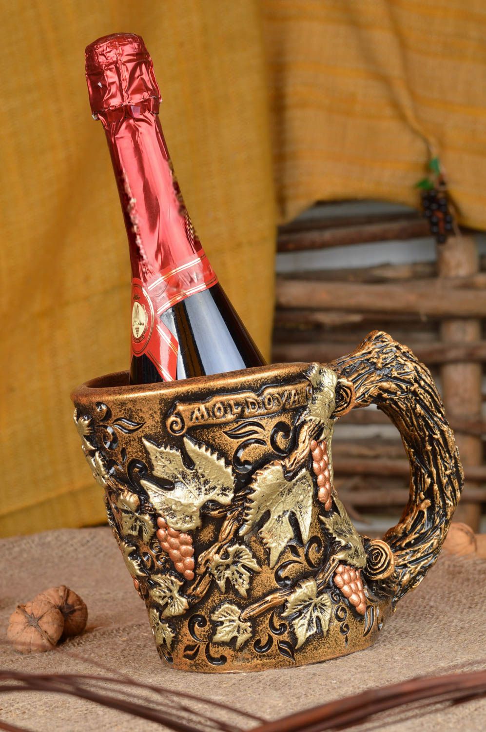 Decorative handmade holder for wine or champagne bottles in form of ceramic mug photo 1