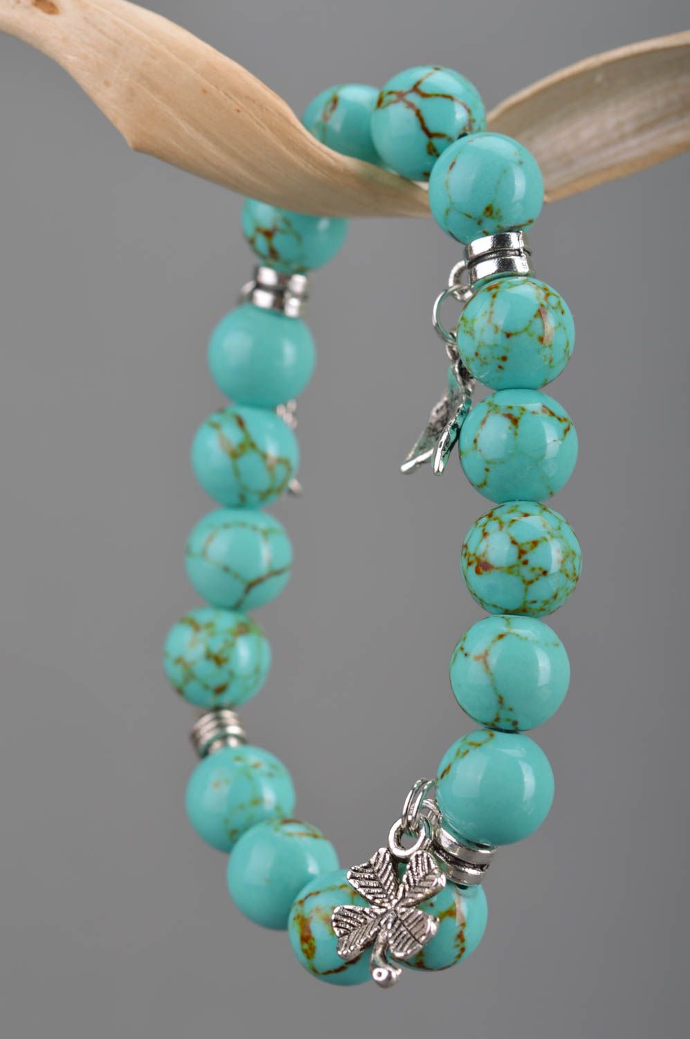 Handmade beaded wrist bracelet styled on turquoise with metal charms fish leaves photo 3