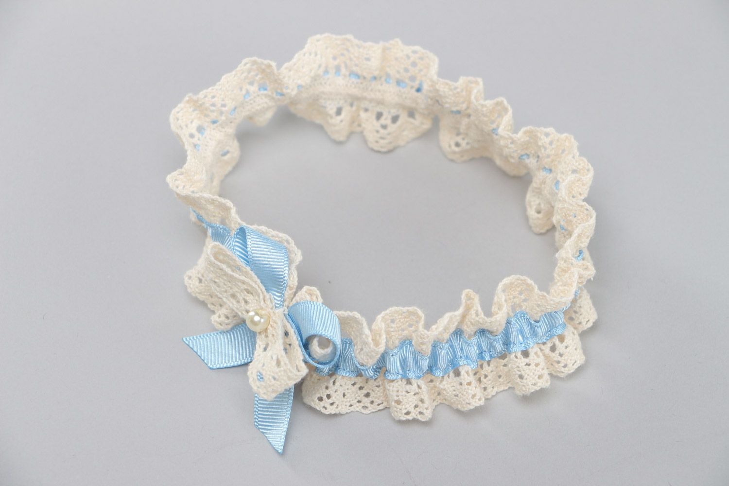 Handmade ivory colored lace bridal garter with tender blue ribbon and pearls photo 2