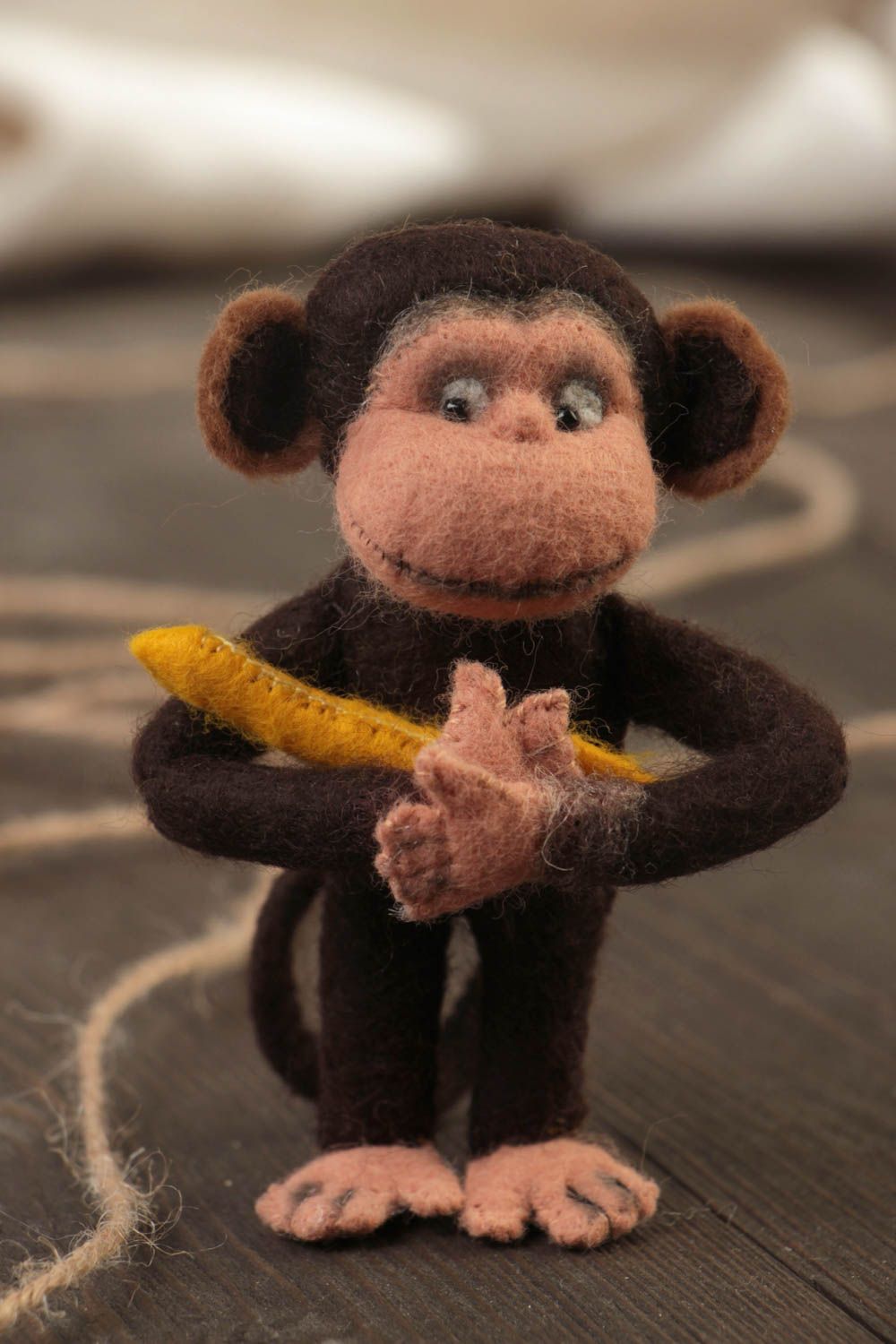 Handmade small designer woolen soft toy charming monkey with banana photo 1