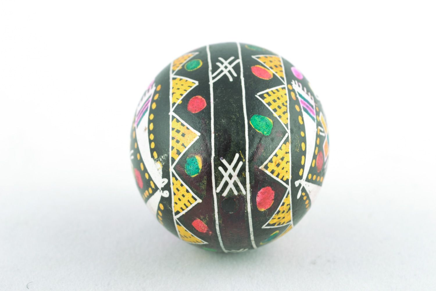 Beautiful chicken Easter egg pysanka with handmade painting on black background photo 4