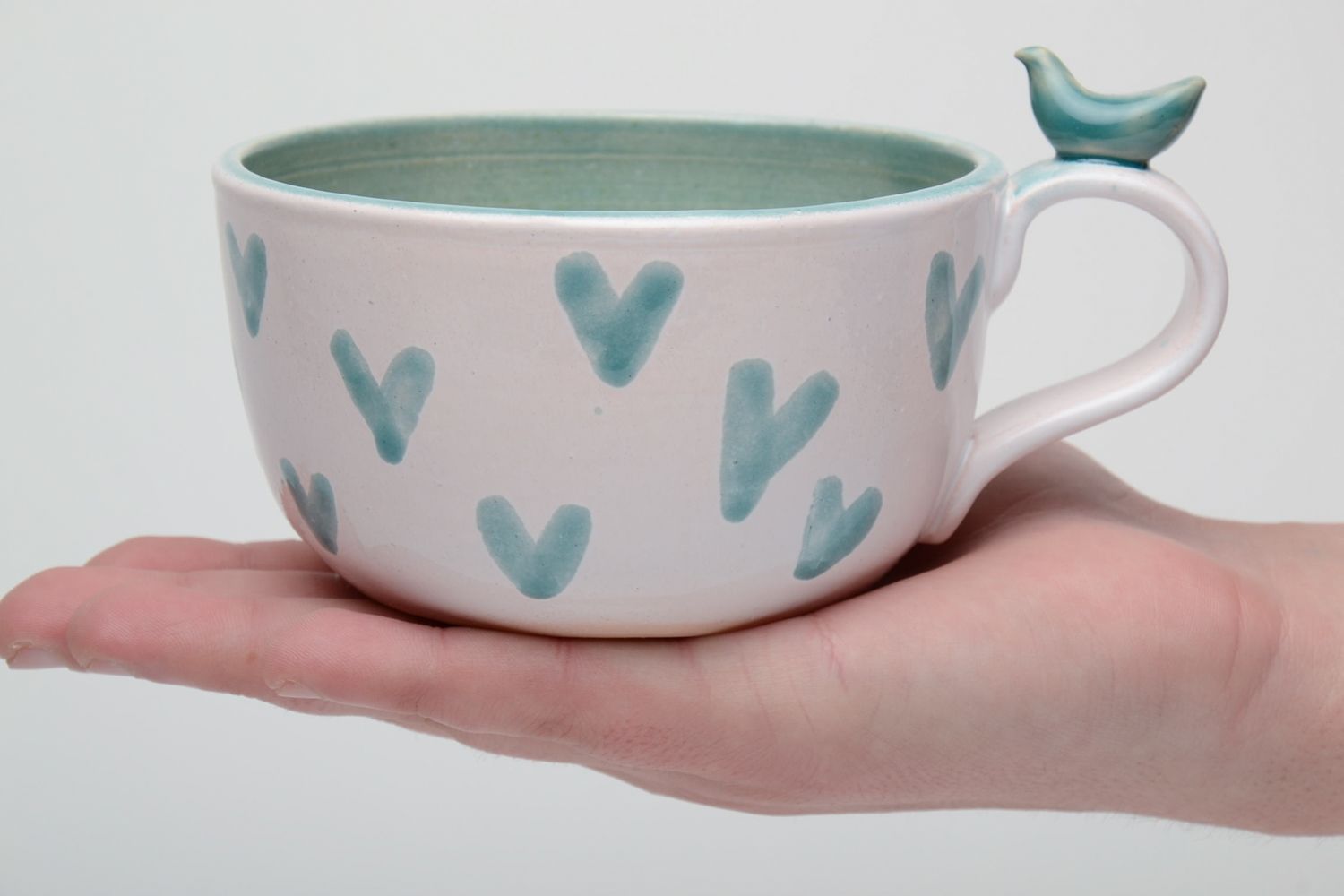 Porcelain white coffee cup with green glaze inside with handle and heart shape pattern photo 5