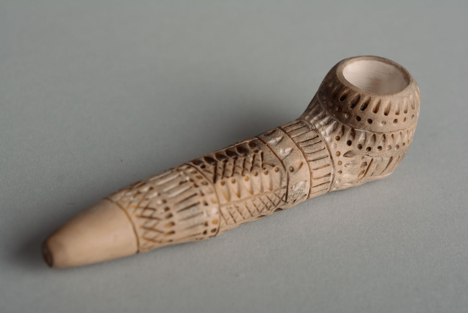 Clay smoking pipe in ethnic style photo 4
