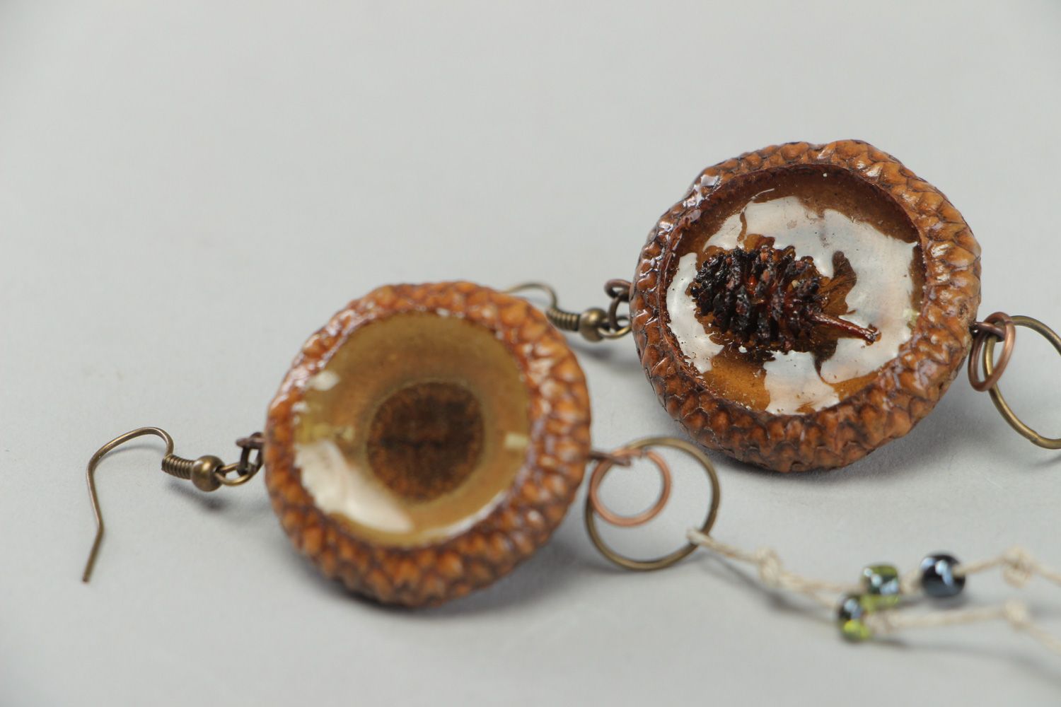 Handmade dangle earrings made of natural materials coated with epoxy resin photo 2