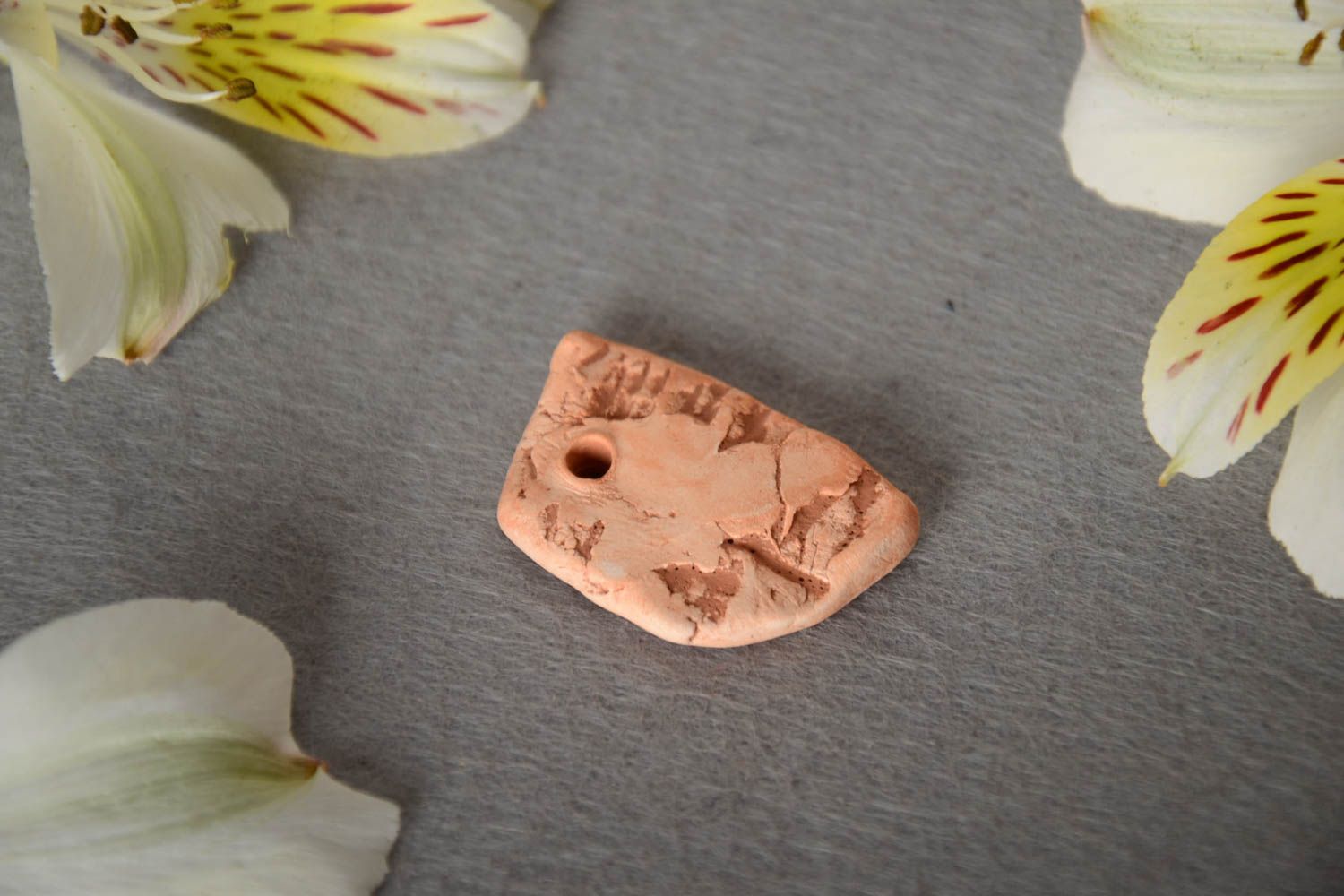 Small homemade ceramic flat jewelry component coated with pigment and embossed photo 1