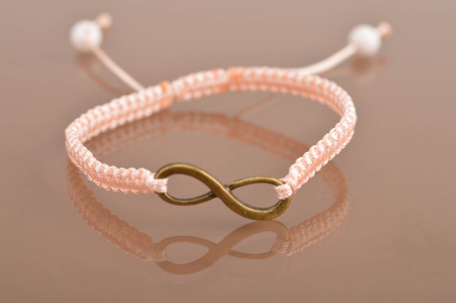 Handmade stylish thin pink woven wrist bracelet made of silk with insert photo 2