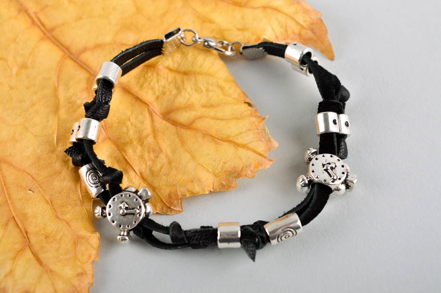 Handmade black cord bracelet with unisex metal charms and beads photo 1