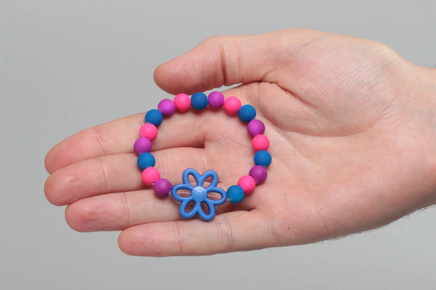 Colorful homemade children's wrist bracelet with plastic beads and flower photo 5