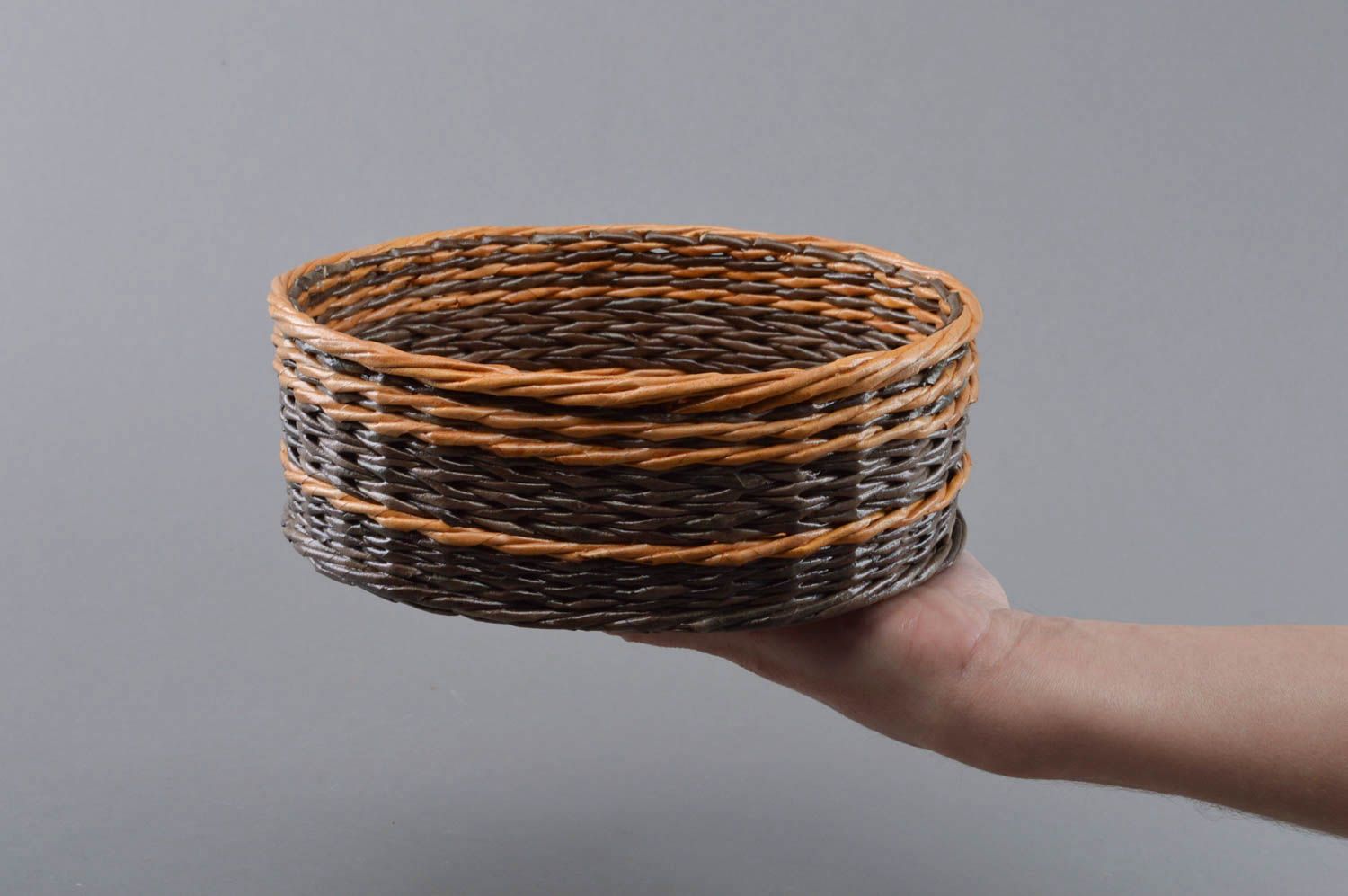 Handmade round brown decorative basket woven of paper rod for interior  photo 1