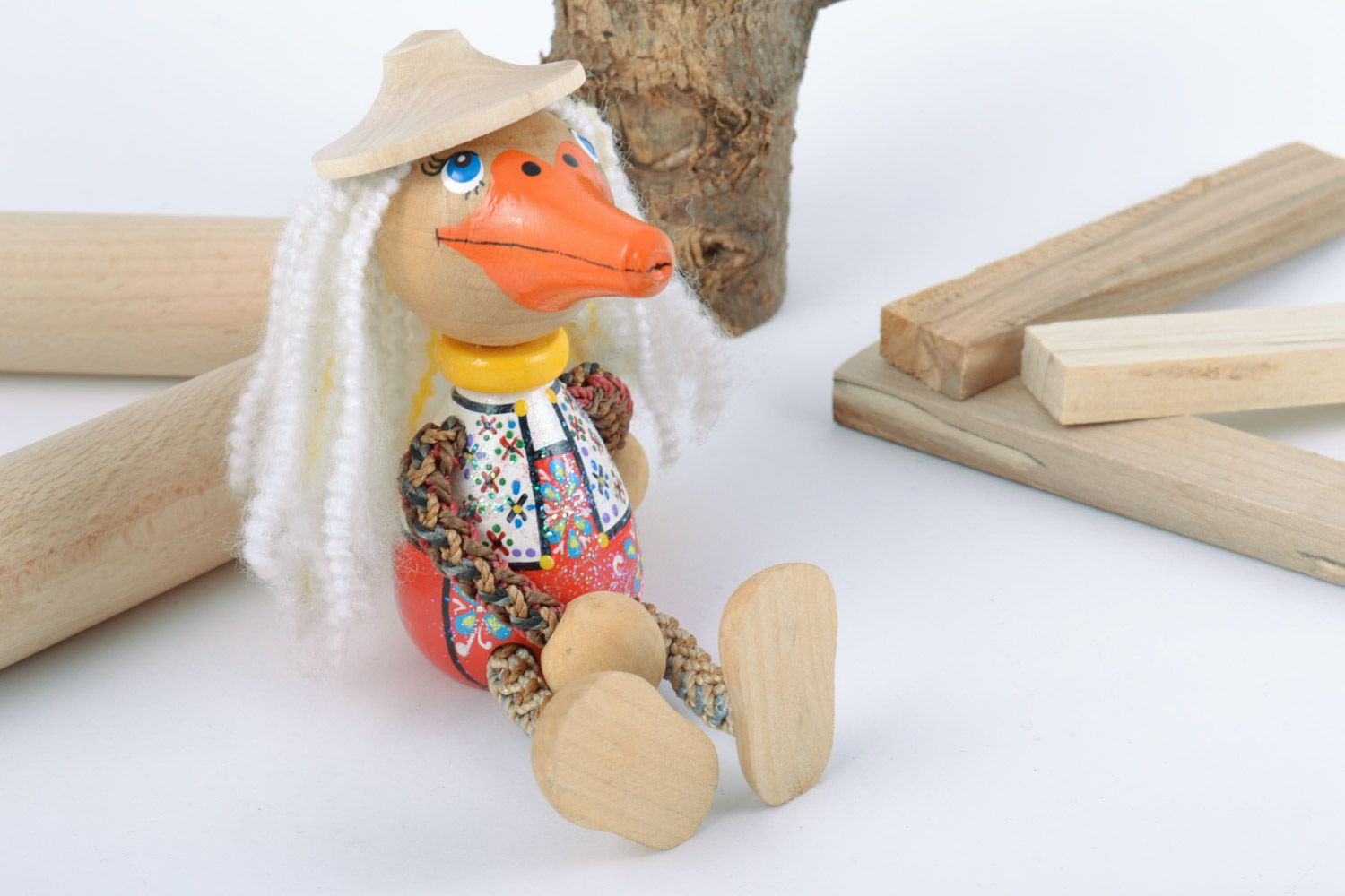 Handmade wooden toy in the shape of duck painted with eco dyes for children photo 1