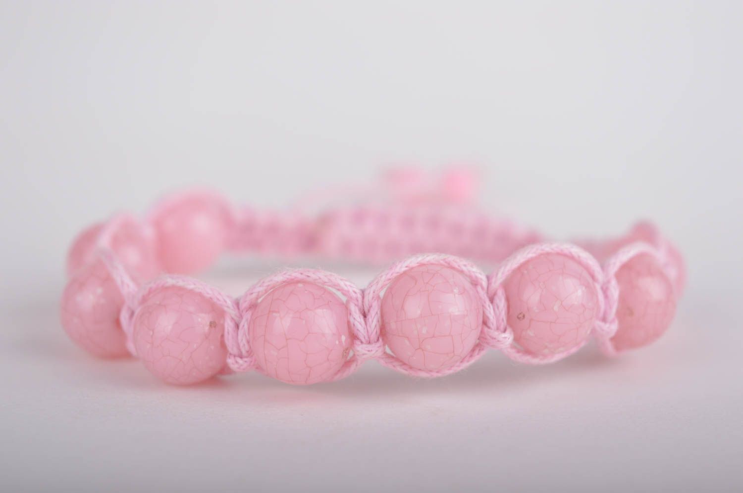 Light pink strand bracelet with pink cord and pink beads photo 3