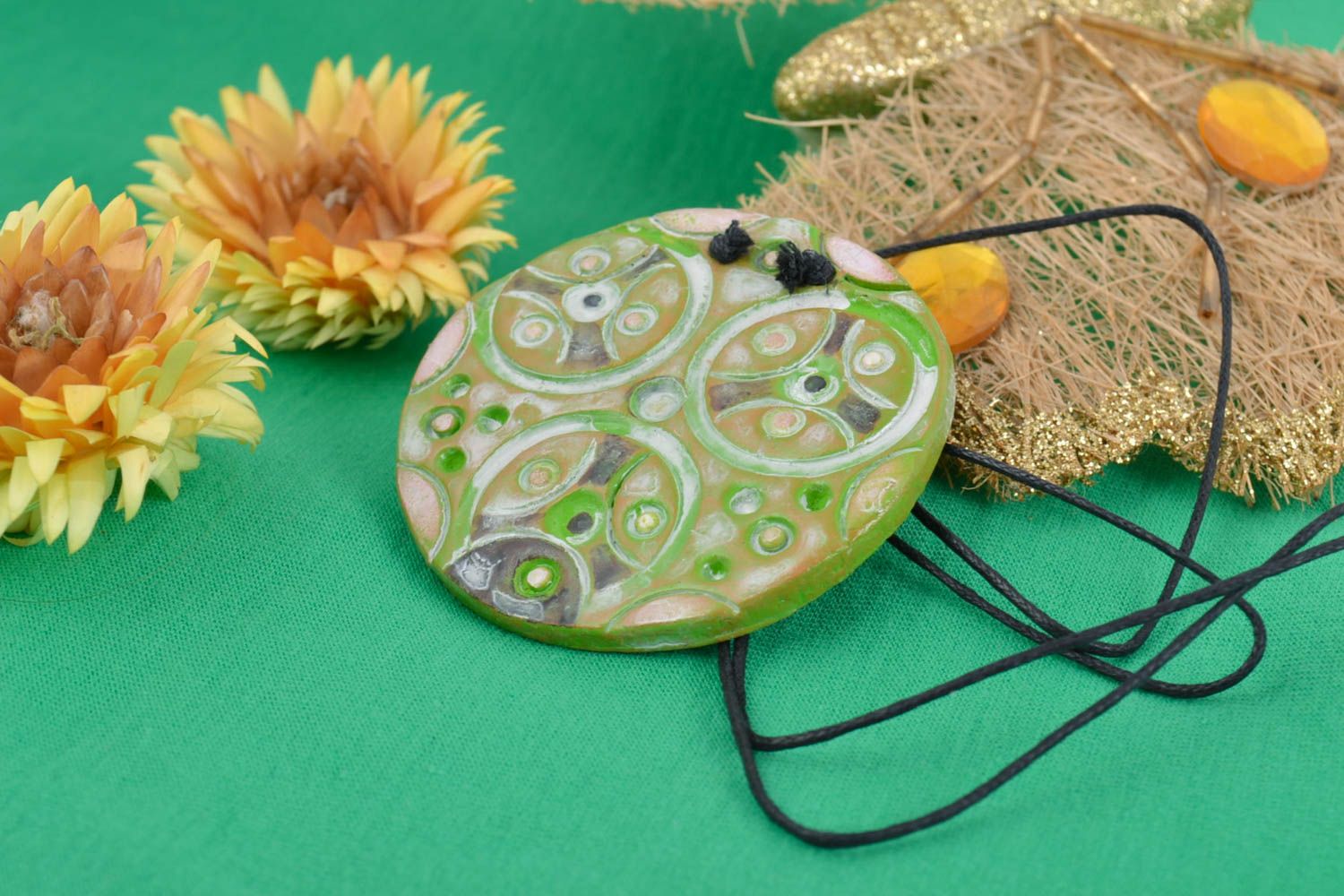 Handmade women's round ceramic pendant of bright green color with ornament photo 1