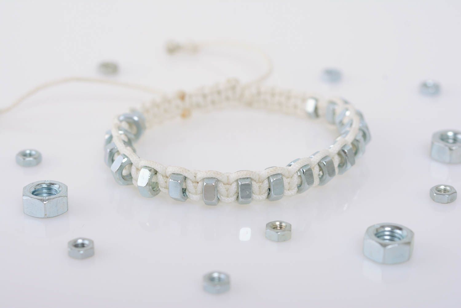 White handmade designer thin macrame woven cord bracelet with nuts photo 1