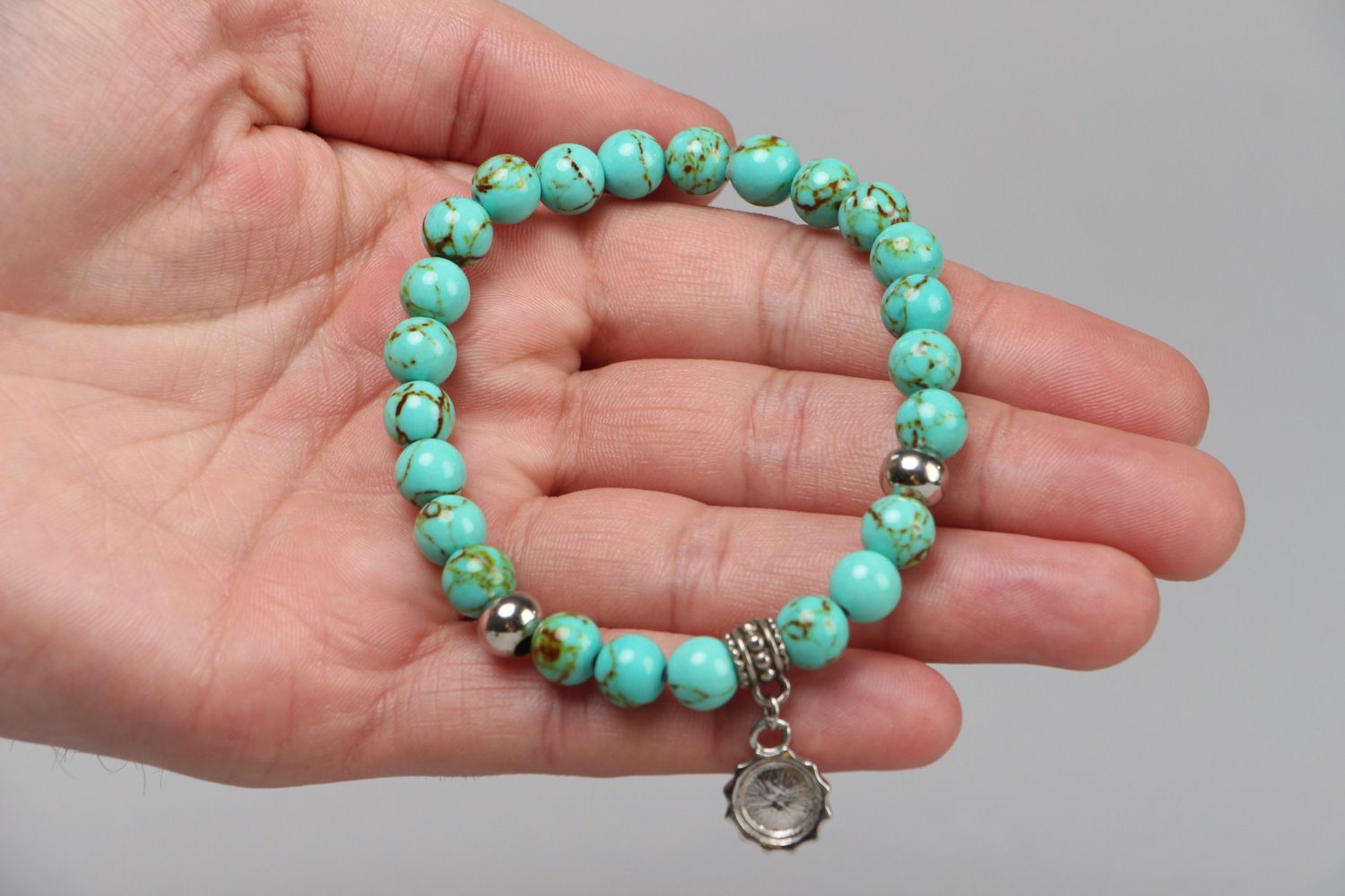 Handmade stretch wrist bracelet with natural turquoise beads and metal charm photo 3
