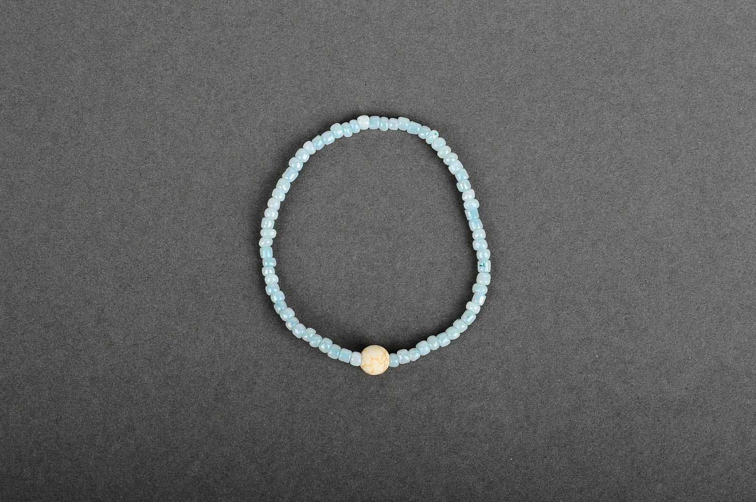 Handmade pale blue beaded stretchy wrist bracelet with beige ball shape centerpiece photo 1